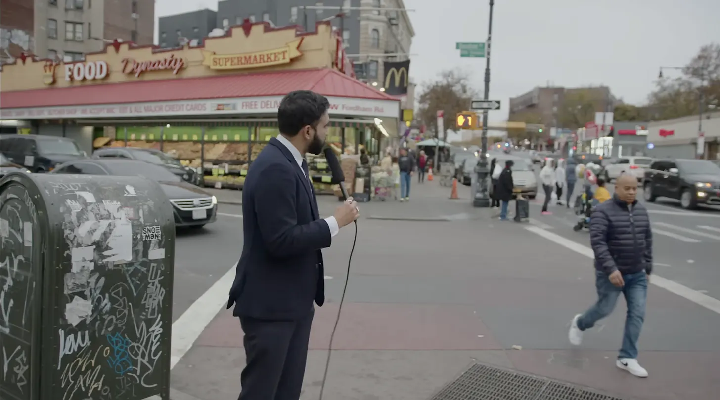 A person in a suit holding a microphone
AI-generated content may be incorrect.